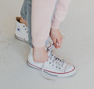 Person Wearing a White Converse Sneakers